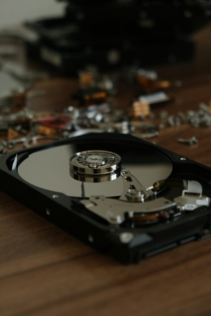 Opened hard drive among loose metal parts
