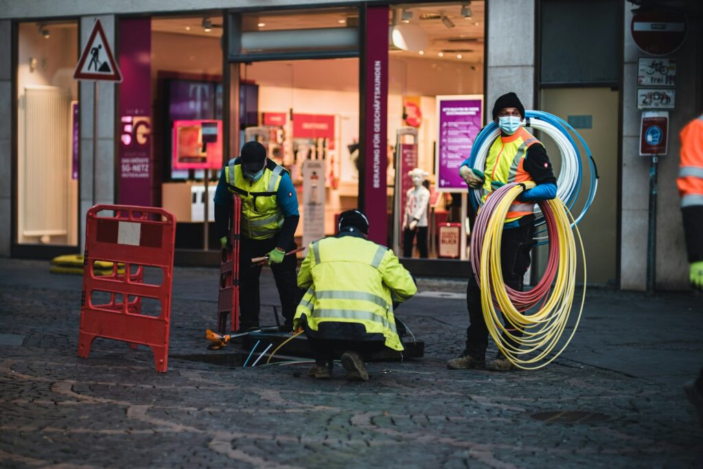 Workers installing fiber optic cable on a city street