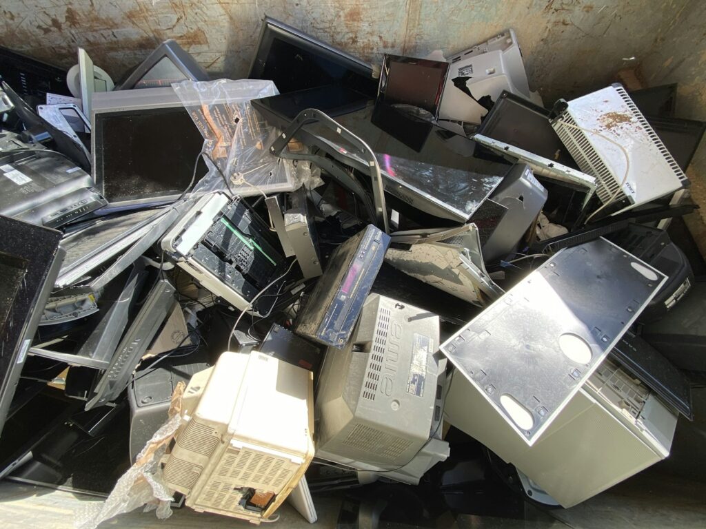 Pile of used computer equipment and power supplies