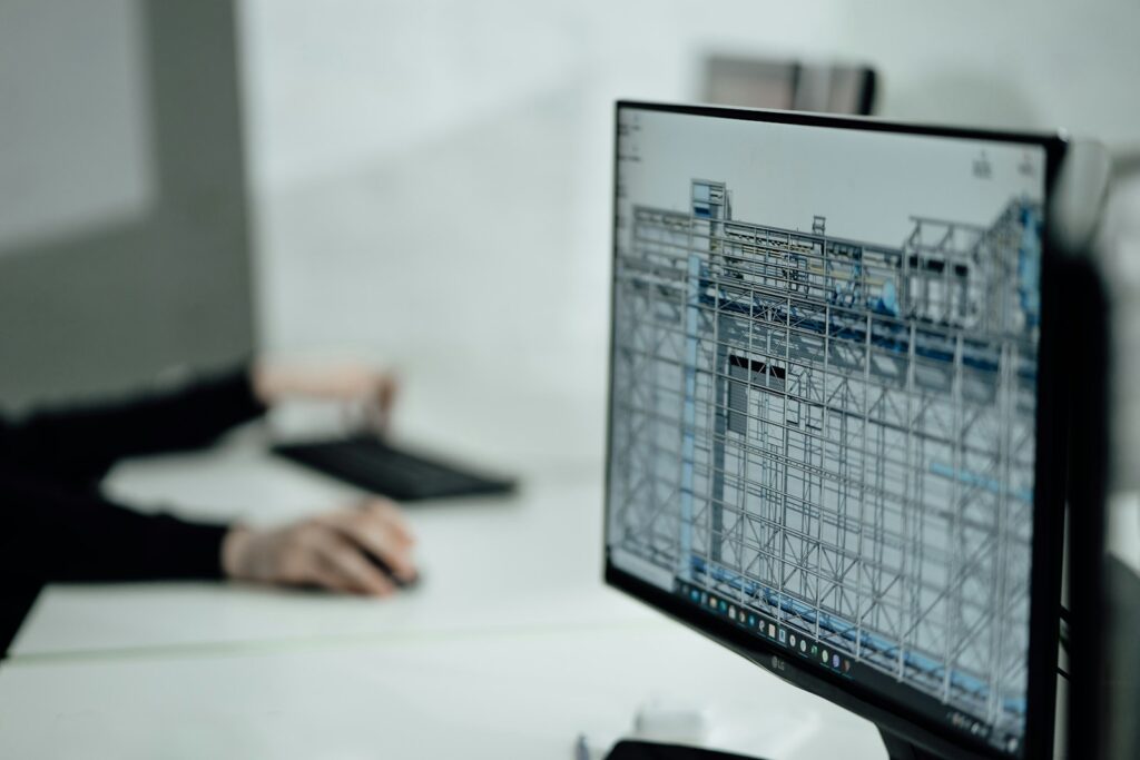 Person reviewing a spreadsheet on a desktop monitor