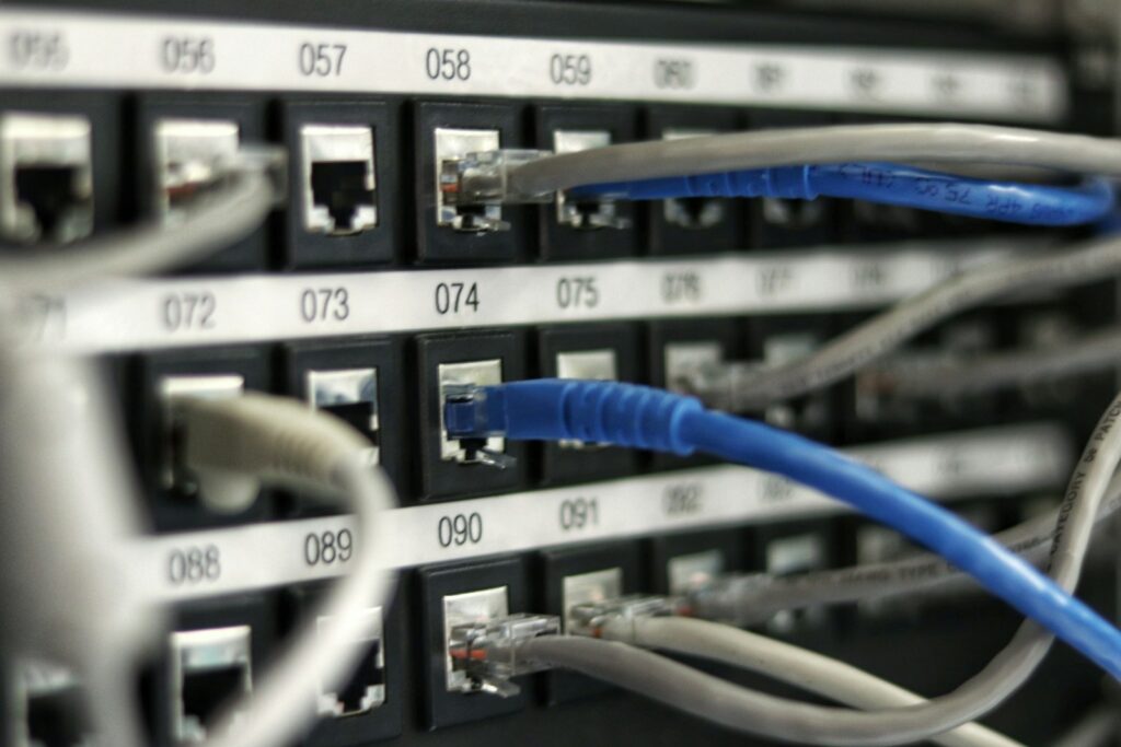 Network switch ports with blue and gray patch cables