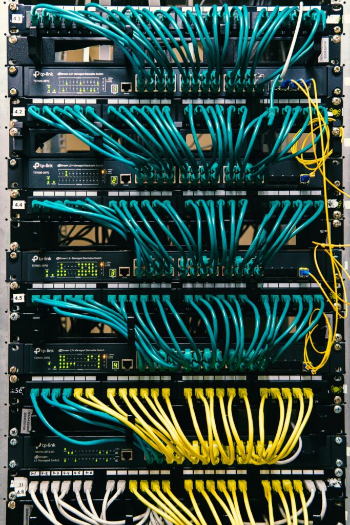 Rack-mounted network switches with teal patch cables