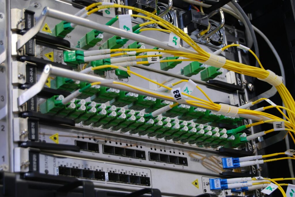 Network rack with fiber optic cables connected to switching equipment