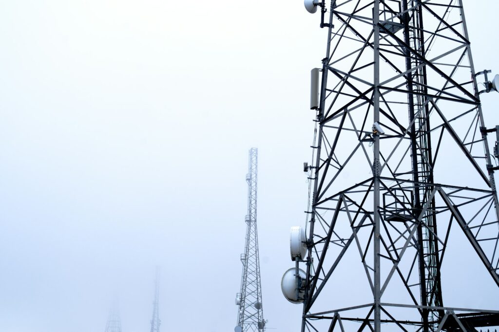 Lattice transmission tower against a pale sky