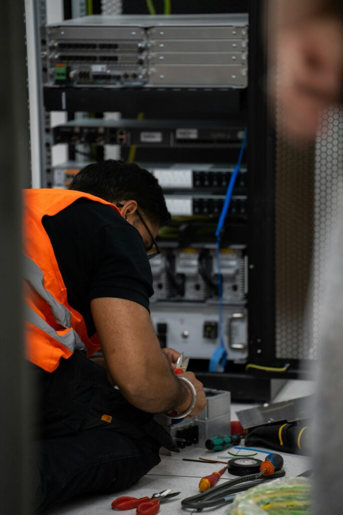 Technician servicing equipment in a server rack